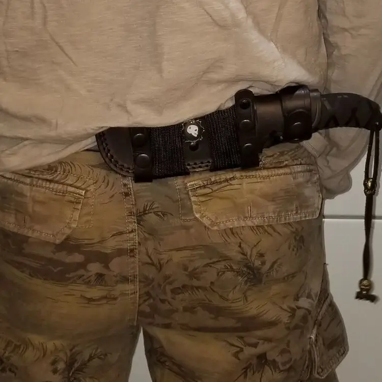 The Ka-Bar Becker BK2 Campanion fixed blade knife shown worn in the horizontal scout carry position on a belt around a men's waist. 